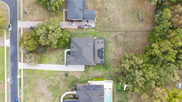 an aerial view of a house with a yard