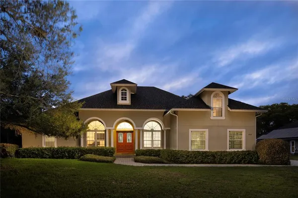 a front view of a house with a garden