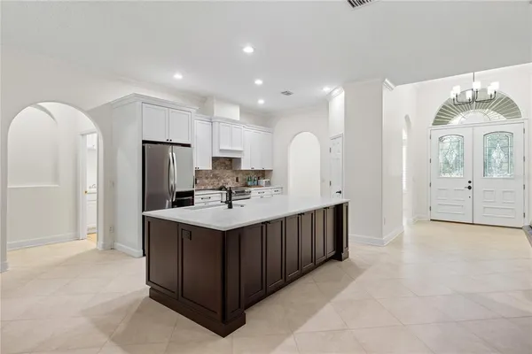 a kitchen with stainless steel appliances a sink stove and cabinets
