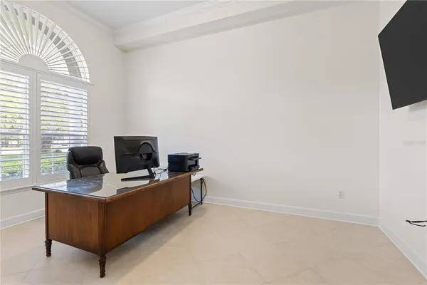 a view of a workspace with furniture and a flat screen tv
