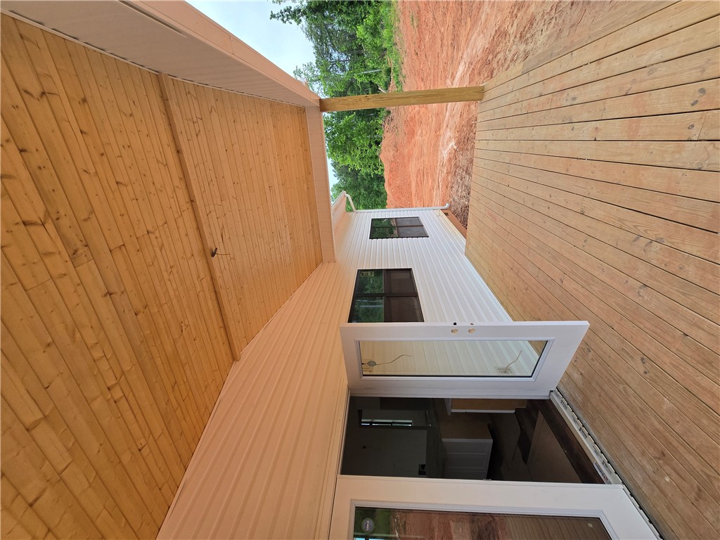 157 Hunting Hollow Road Six Mile, SC 29682 - Photo 5 of 19 A spacious wooden deck extends from a new-construction home with white siding, ideal for outdoor living.