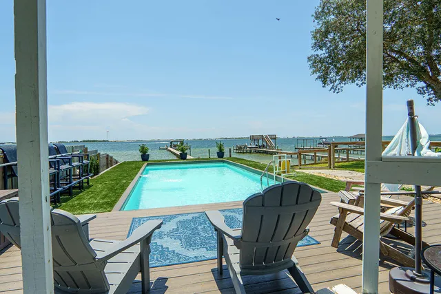 a living room with a couch a table and a potted plant