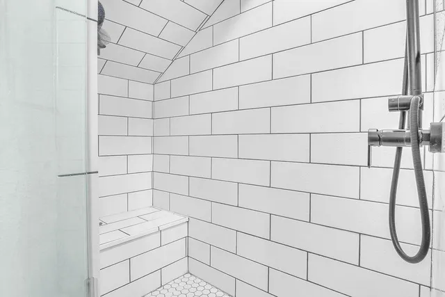 a bedroom with a bed and painting on the wall