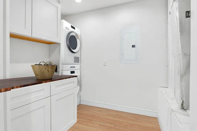 a view of a workspace with furniture and wooden floor