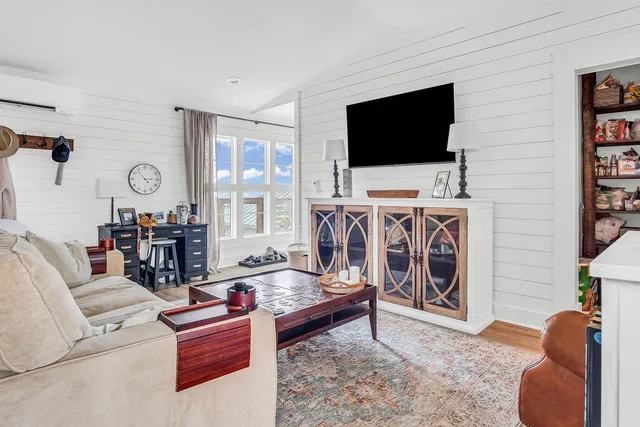 a living room with a fireplace and a flat screen tv