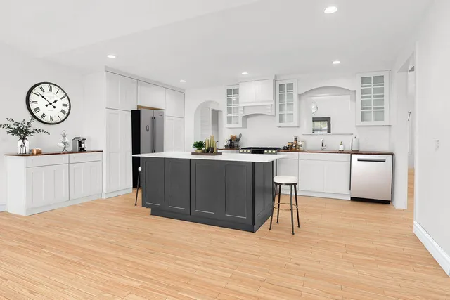 a large white bed in a white room