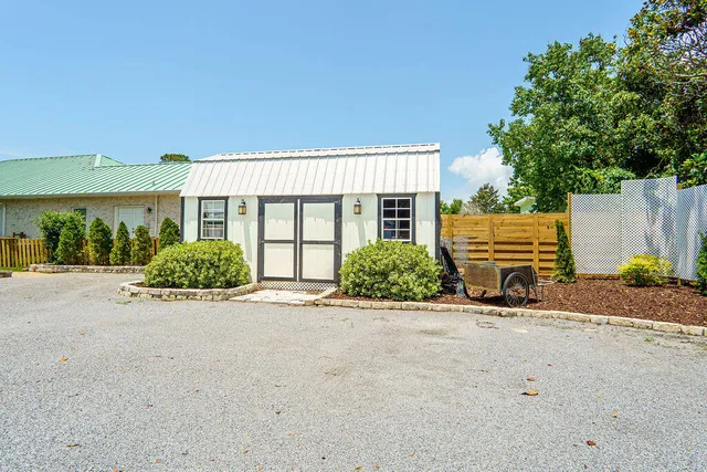 a view of a house with a big yard and sitting area