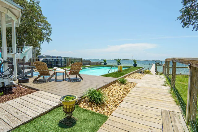 a living room with furniture a rug and a large window
