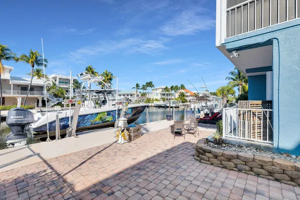 a kitchen with stainless steel appliances kitchen island granite countertop a refrigerator and a stove top oven
