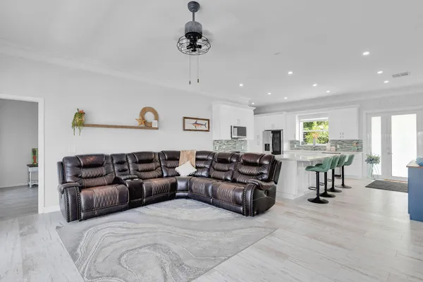 a kitchen with stainless steel appliances granite countertop a sink a stove and a refrigerator