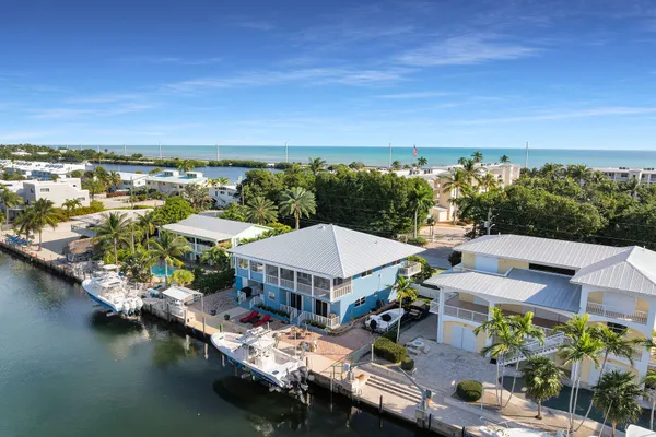 a view of the house with backyard and sitting area