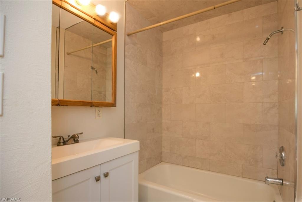 524 97th Avenue North, Unit B Naples, FL 34108 - Photo 2 of 13 a bathroom with a sink a toilet and shower