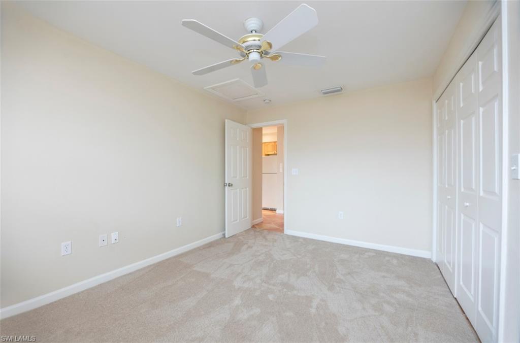 524 97th Avenue North, Unit B Naples, FL 34108 - Photo 5 of 13 an empty room with fan and windows