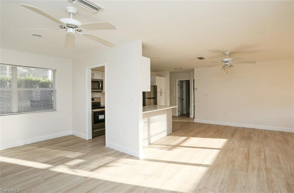 524 97th Avenue North, Unit B Naples, FL 34108 - Photo 6 of 13 a view of a livingroom with wooden floor