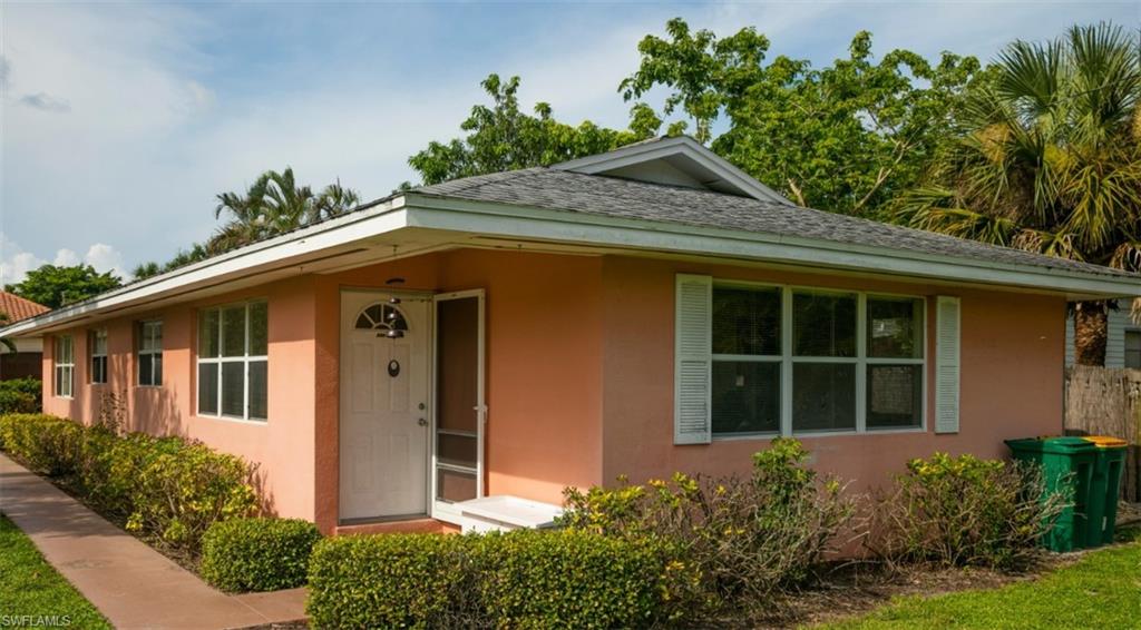524 97th Avenue North, Unit B Naples, FL 34108 - Photo 8 of 13 a front view of a house with a yard
