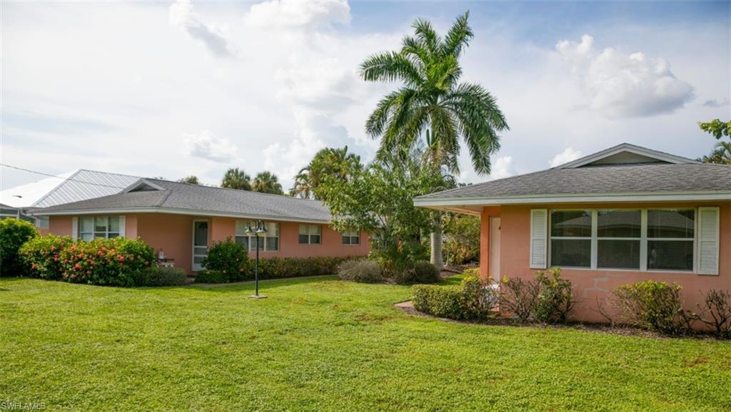 524 97th Avenue North, Unit B Naples, FL 34108 - Photo 9 of 13 a view of a house with a yard and potted plants