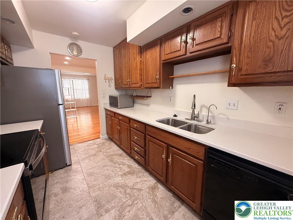 170 Springhouse Road Allentown, PA 18104 - Photo 9 of 23 Functional kitchen with ample cabinet storage and easy access to an adjoining living space.
