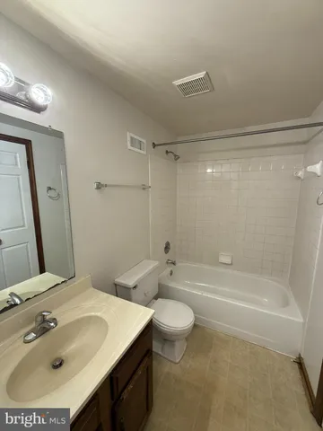 a bathroom with a sink a toilet and a bathtub