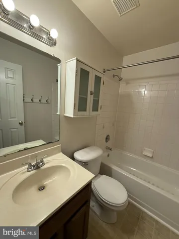 a bathroom with a sink toilet tub and shower