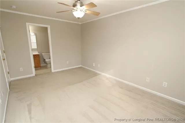 an empty room with a chandelier fan and closet