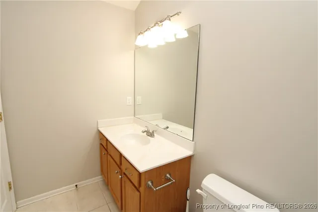 a bathroom with a sink a toilet and vanity