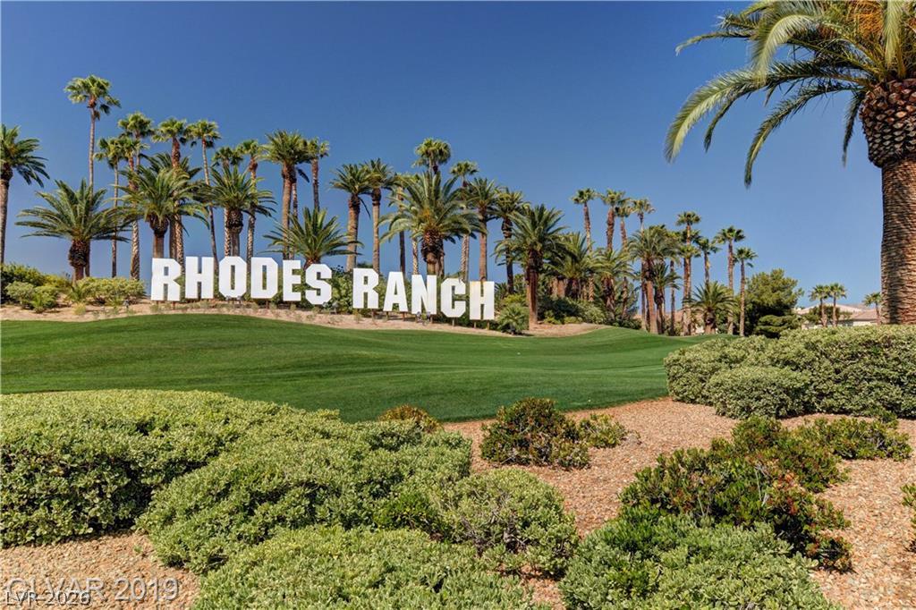 87 Tall Ruff Drive Las Vegas, NV 89148 - Photo 14 of 71 Green landscaping with towering palms marks the entrance to Rhodes Ranch, a vibrant community.