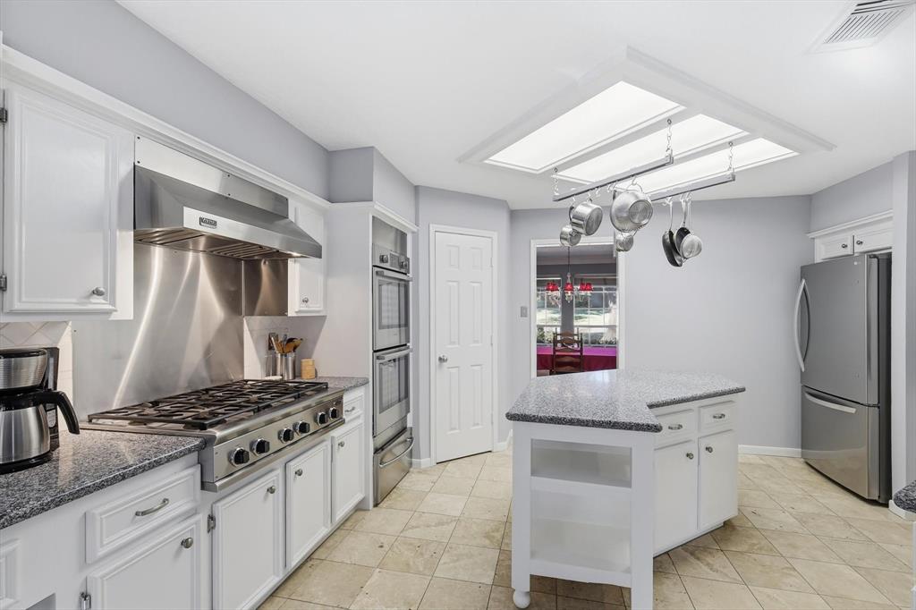 7608 Tallow Road Irving, TX 75063 - Photo 12 of 40 a kitchen with granite countertop a sink stove and refrigerator