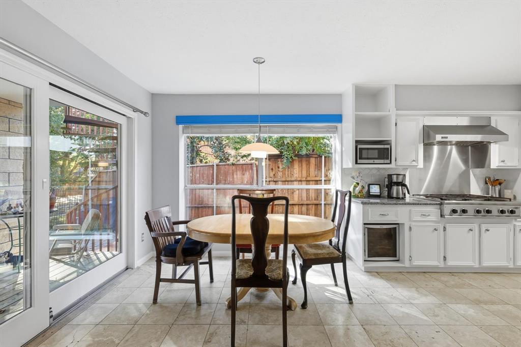 7608 Tallow Road Irving, TX 75063 - Photo 13 of 40 a view of a dining room with furniture large windows and wooden floor