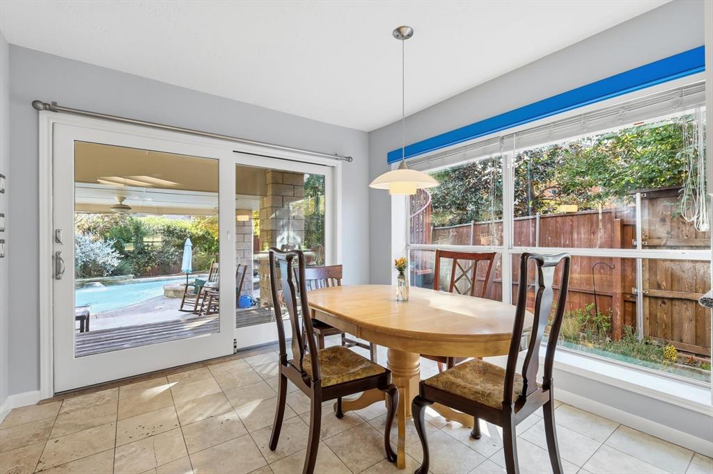 7608 Tallow Road Irving, TX 75063 - Photo 14 of 40 a view of a dining room with furniture large windows and wooden floor