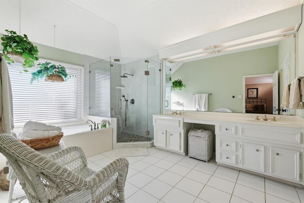 7608 Tallow Road Irving, TX 75063 - Photo 21 of 40 a spacious bathroom with a granite countertop sink and a mirror