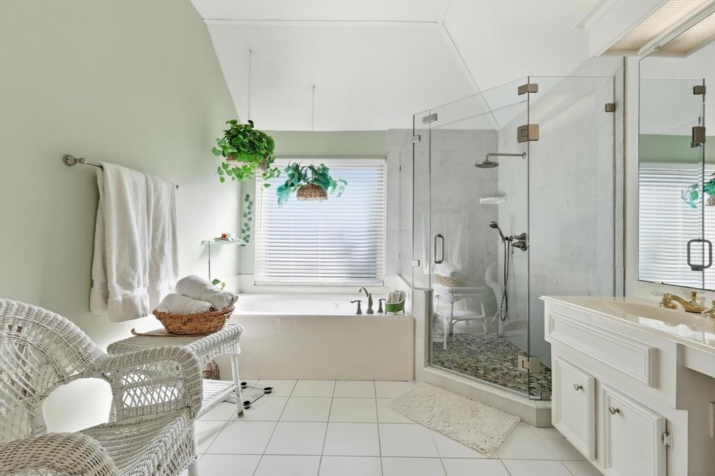 7608 Tallow Road Irving, TX 75063 - Photo 22 of 40 a bathroom with a tub shower and sink