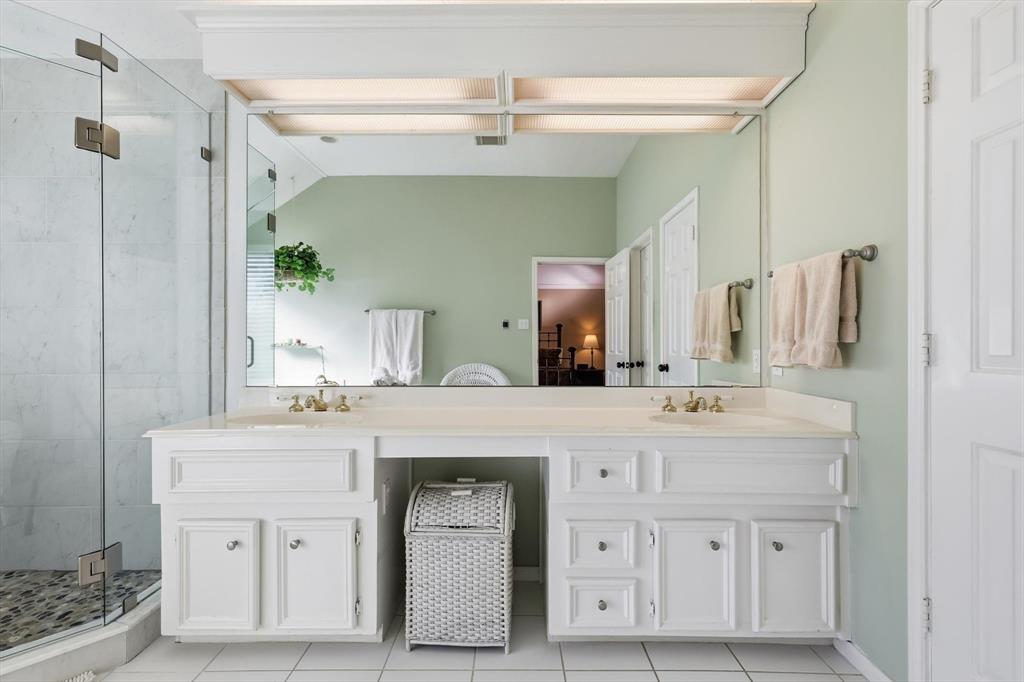 7608 Tallow Road Irving, TX 75063 - Photo 23 of 40 a spacious bathroom with a double vanity sink and a mirror