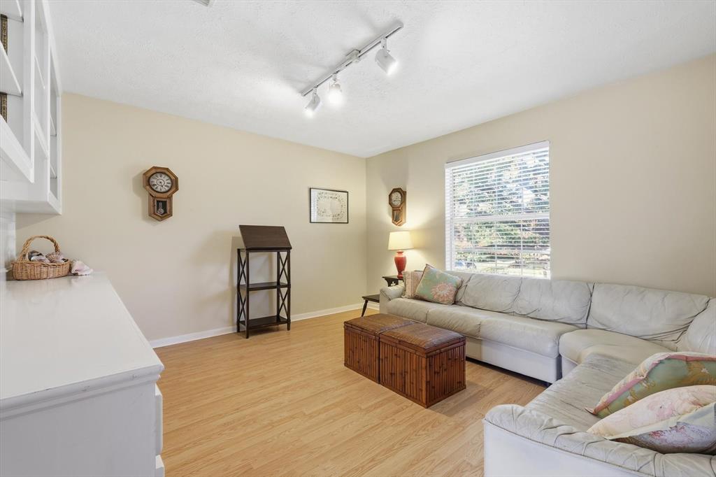 7608 Tallow Road Irving, TX 75063 - Photo 25 of 40 a living room with furniture and a window