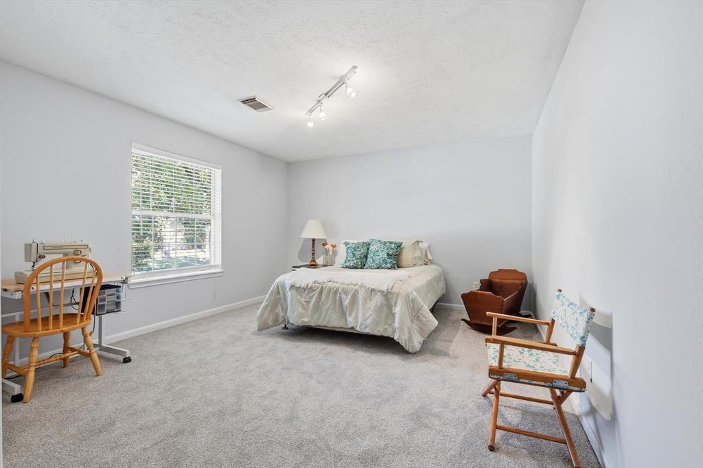 7608 Tallow Road Irving, TX 75063 - Photo 27 of 40 a bedroom with furniture and a window
