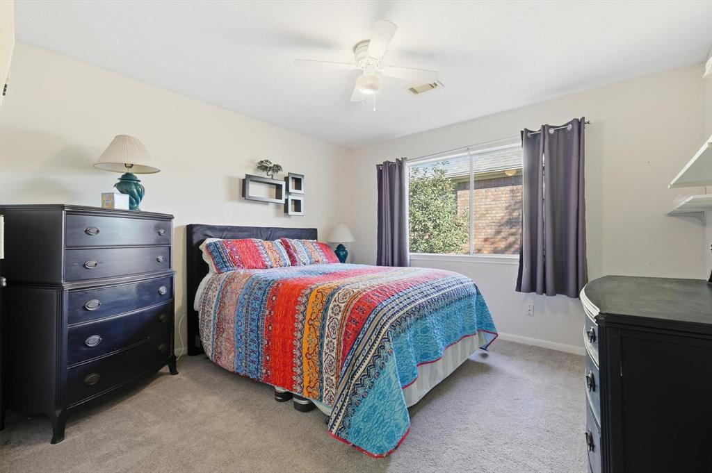 7608 Tallow Road Irving, TX 75063 - Photo 28 of 40 a bed sitting in a bedroom next to a window