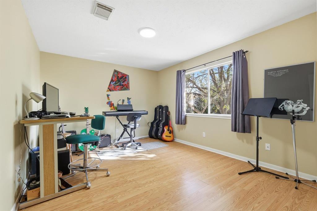 7608 Tallow Road Irving, TX 75063 - Photo 29 of 40 a view of a workspace with furniture and a flat screen tv