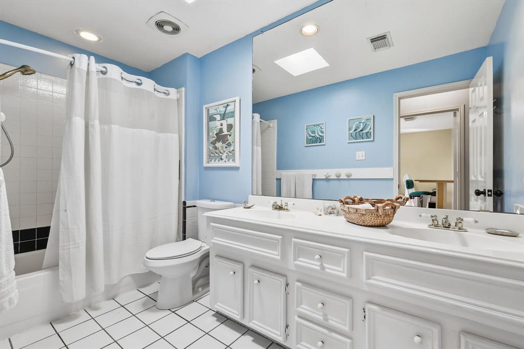 7608 Tallow Road Irving, TX 75063 - Photo 30 of 40 a bathroom with a sink toilet and shower