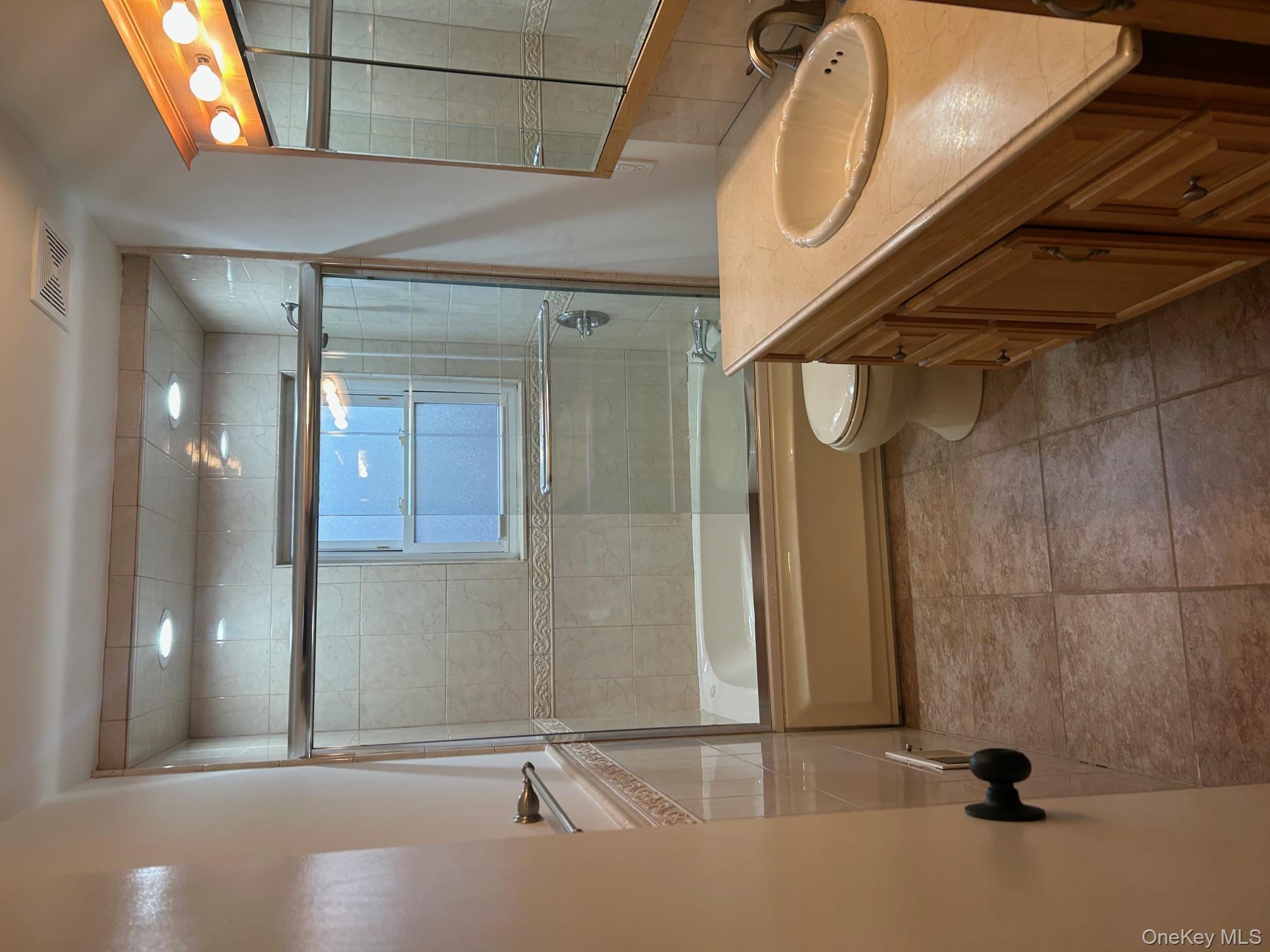 676 Front Street, Unit F Hempstead, NY 11550 - Photo 16 of 19 Full bath with vanity, combined bath / shower with glass door, light tile patterned flooring, and recessed lighting