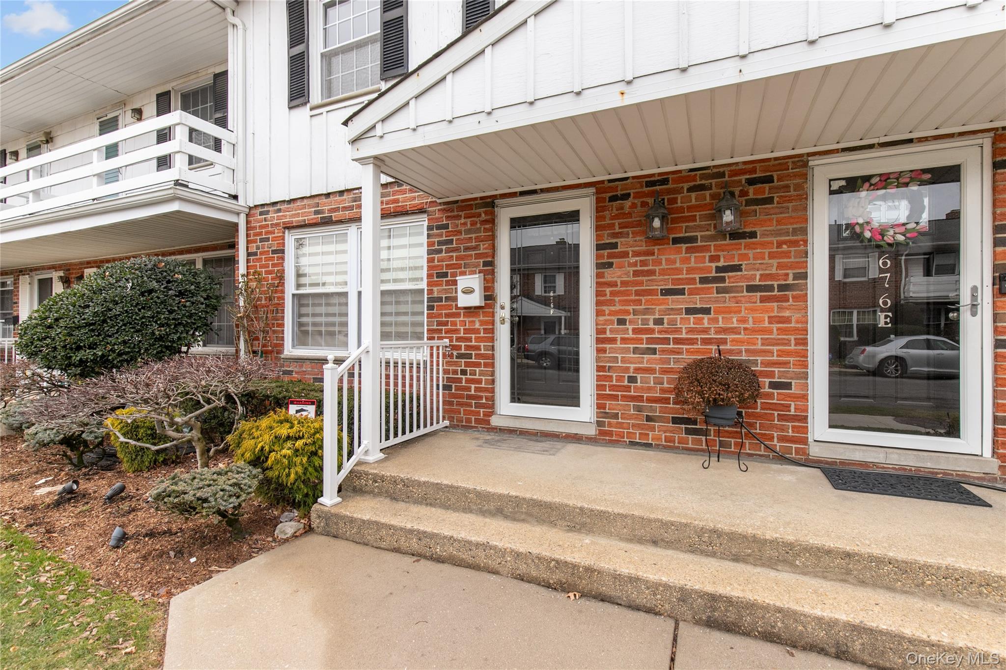 676 Front Street, Unit F Hempstead, NY 11550 - Photo 3 of 18 a front view of a house with a yard