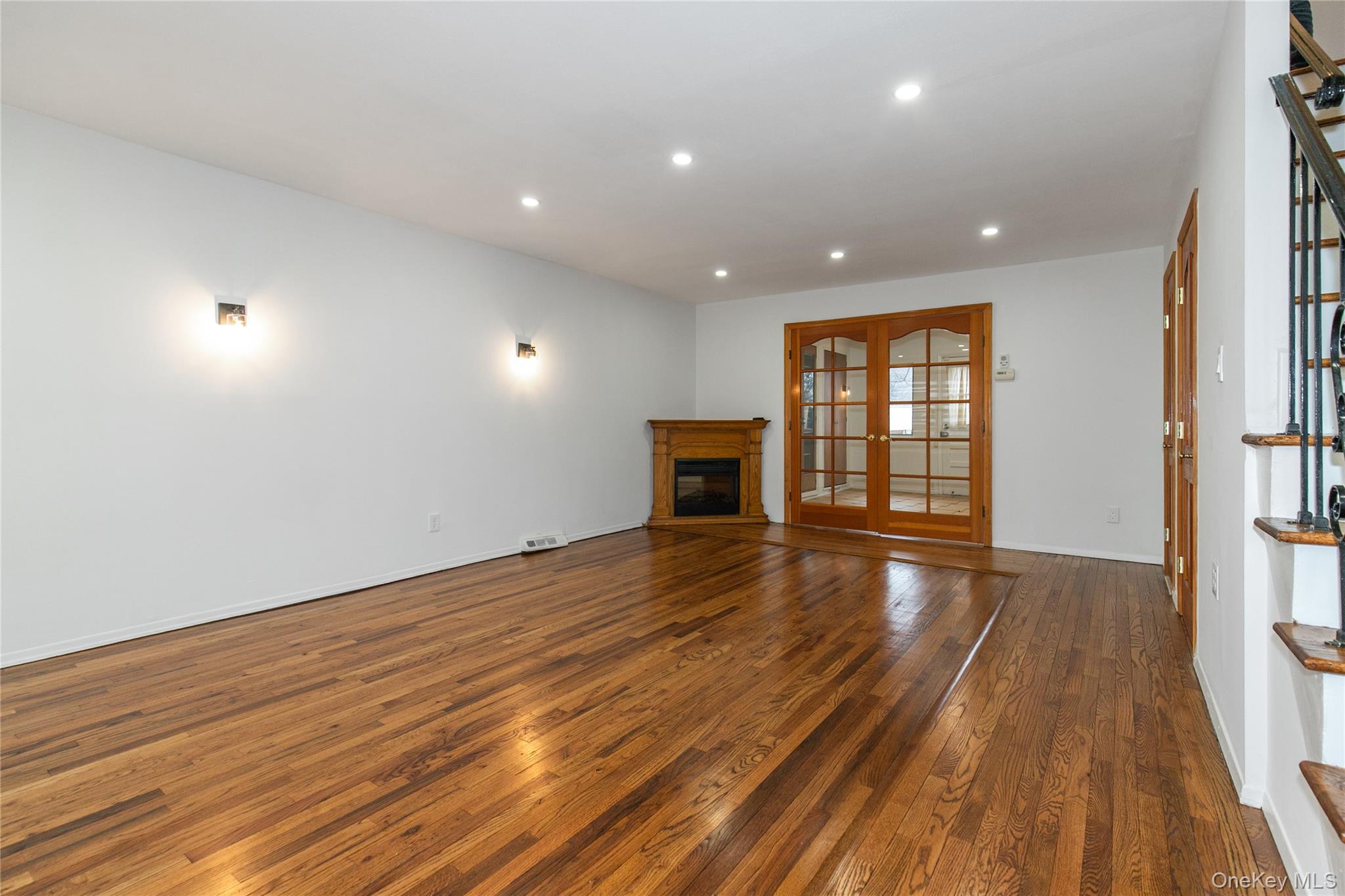 676 Front Street, Unit F Hempstead, NY 11550 - Photo 4 of 18 a view of an empty room with wooden floor and a window