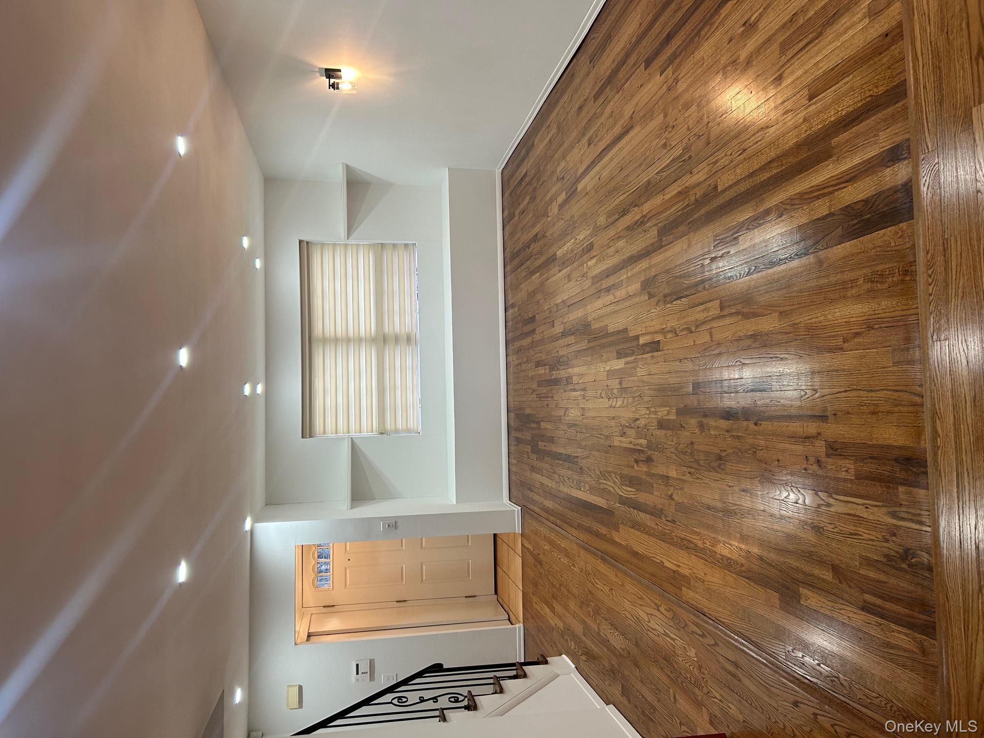 676 Front Street, Unit F Hempstead, NY 11550 - Photo 5 of 19 Unfurnished living room with stairway, dark wood-style flooring, and recessed lighting