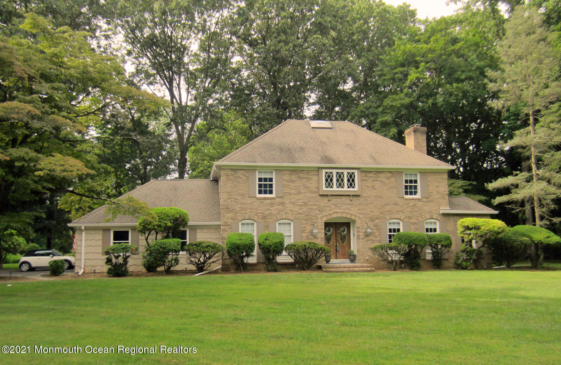 24 Beaver Dam Road Colts Neck, NJ 07722 - Photo 1 of 31 a front view of a house with a garden