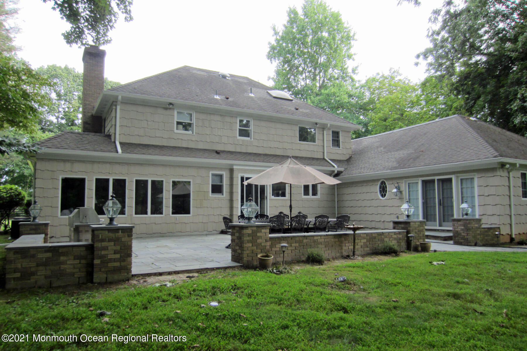 24 Beaver Dam Road Colts Neck, NJ 07722 - Photo 21 of 31 a front view of a house with a yard table and chairs