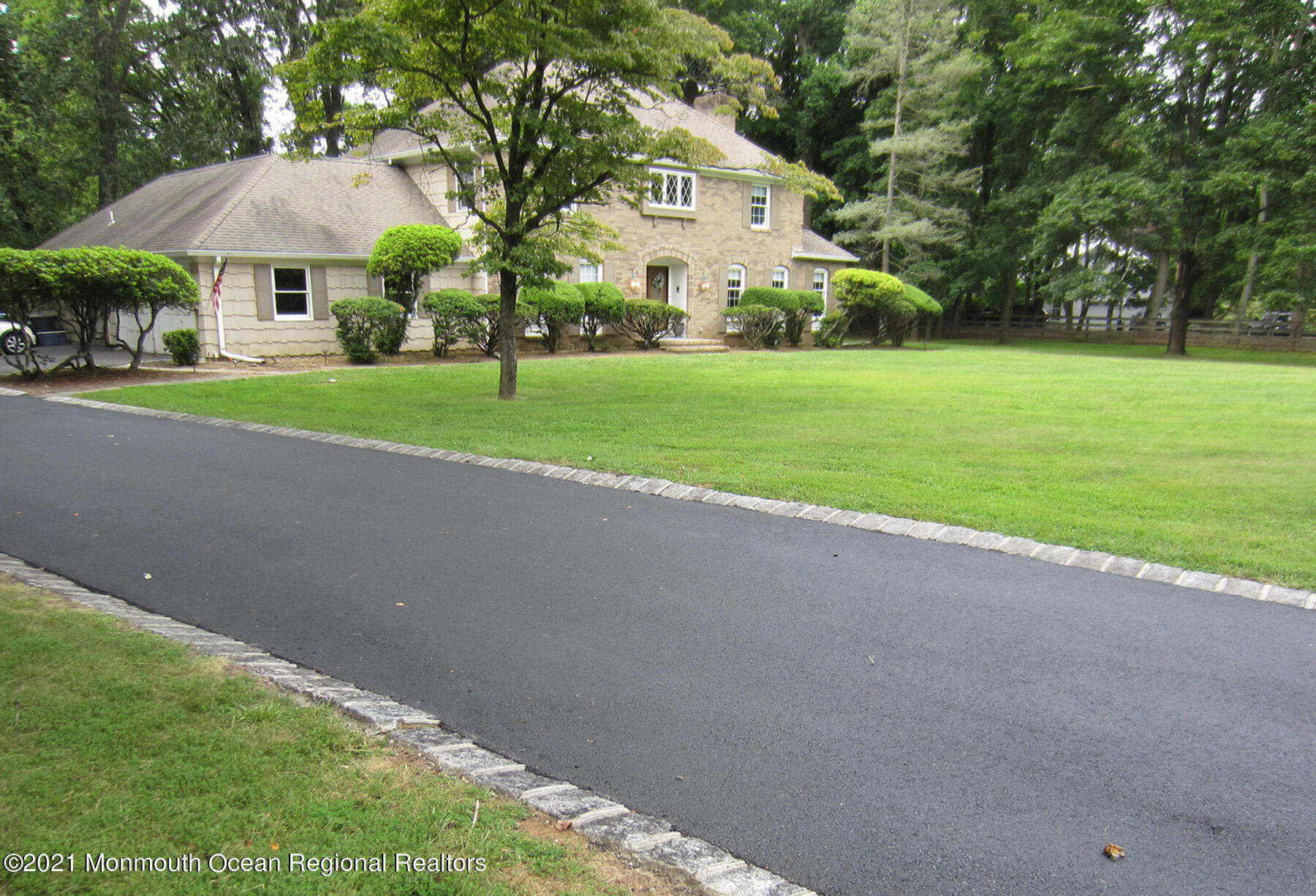 24 Beaver Dam Road Colts Neck, NJ 07722 - Photo 27 of 31 a front view of a house with yard and green space
