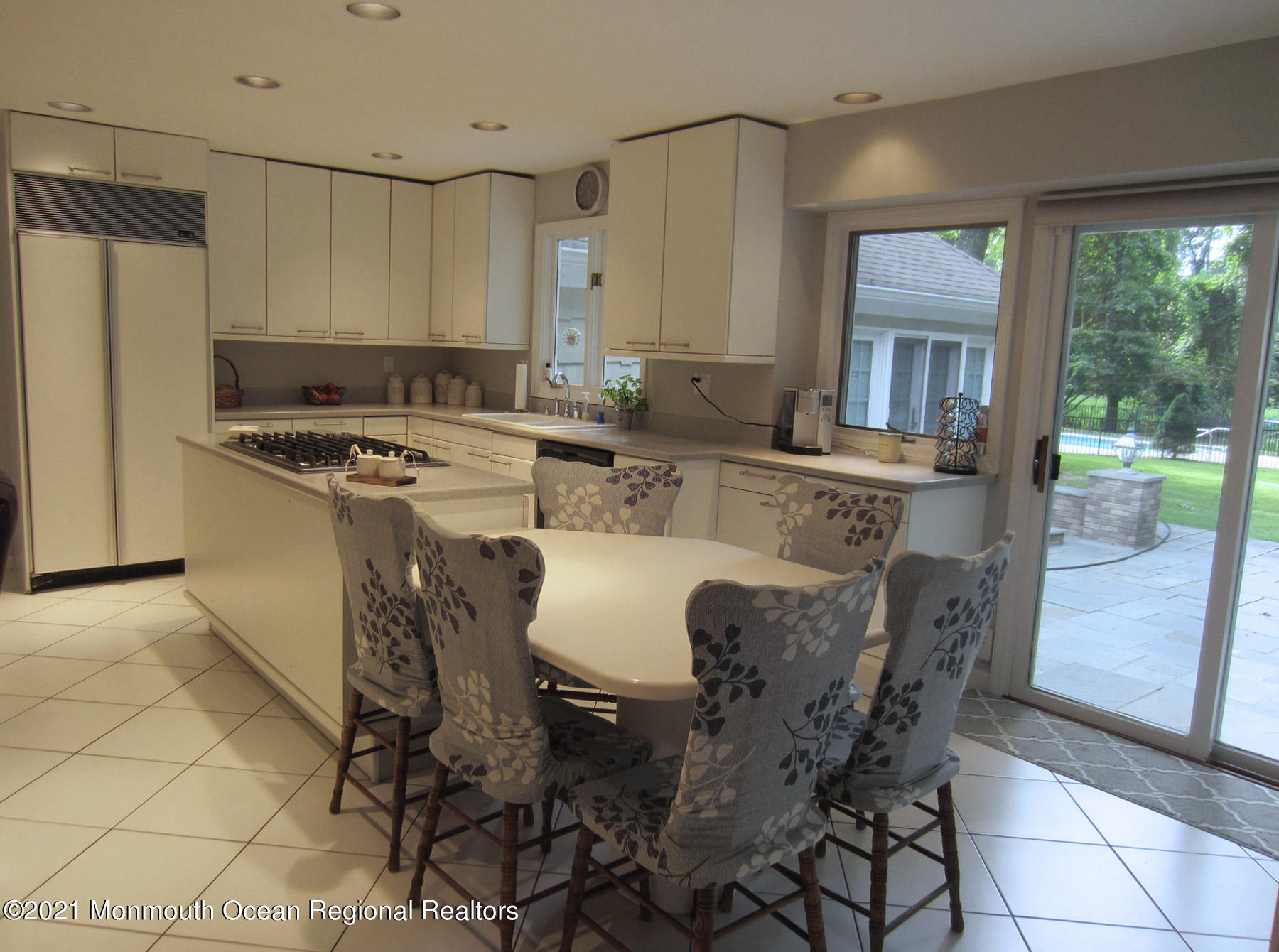 24 Beaver Dam Road Colts Neck, NJ 07722 - Photo 8 of 31 a kitchen with a table chairs stove and refrigerator