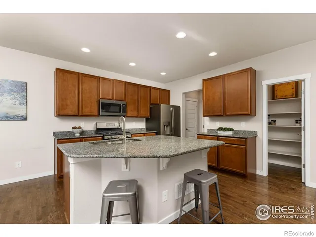 a kitchen with stainless steel appliances granite countertop a stove top oven a sink and dishwasher