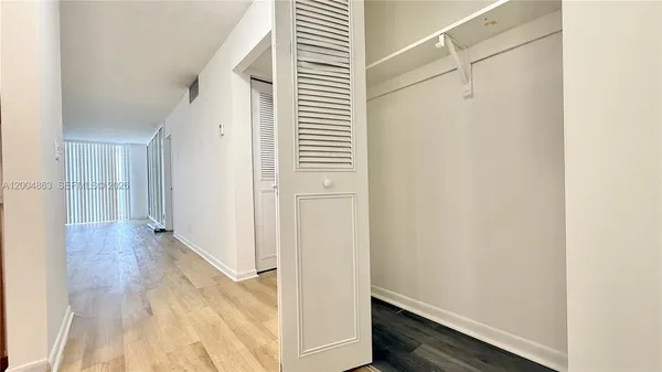a view of a hallway with wooden floor