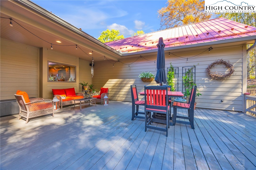 2650 Carson Woods Road Laurel Springs, NC 28644 - Photo 36 of 50 an outdoor sitting area with a table and chairs