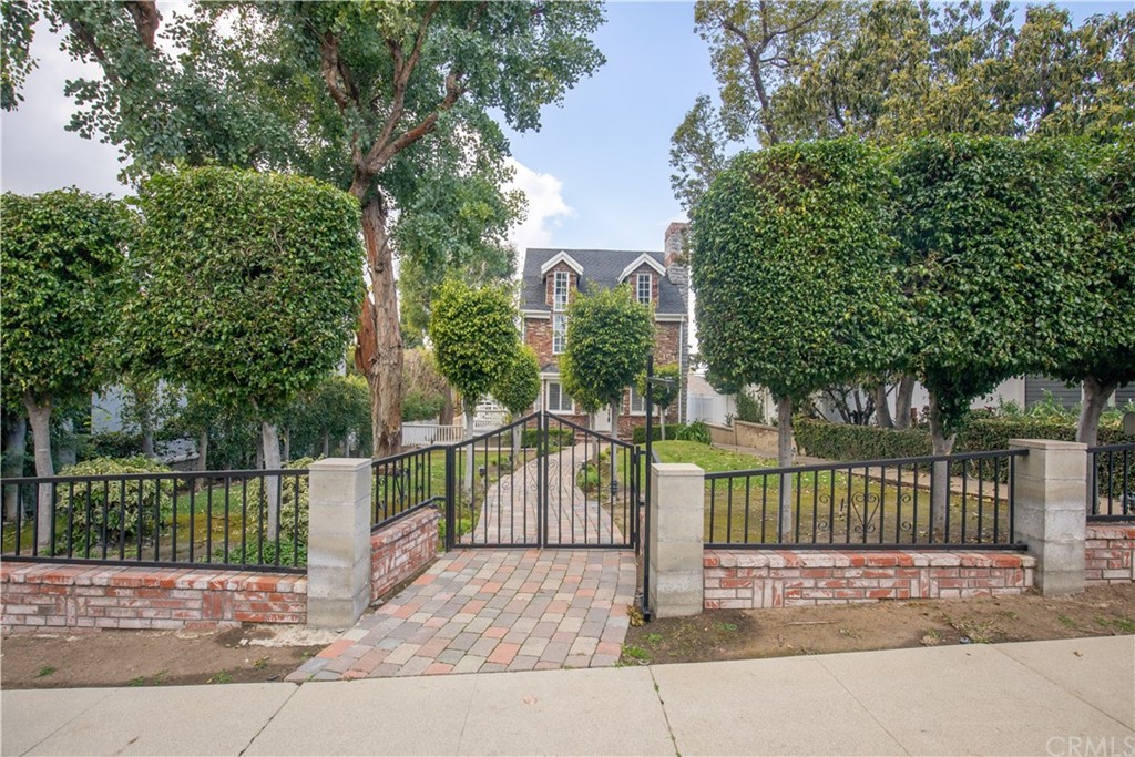 a view of a park with iron fence
