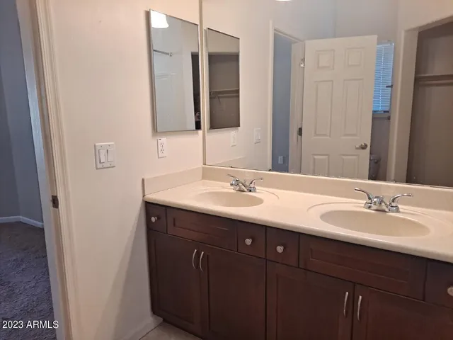 a bathroom with a double vanity sink and a mirror